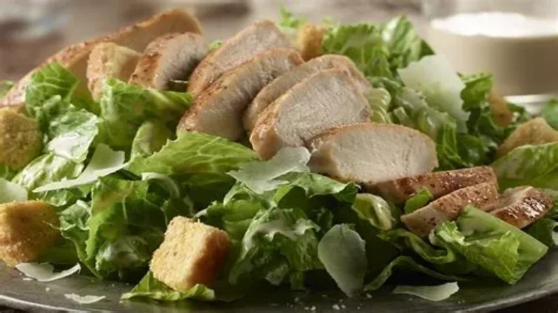 Fresh Caesar salad bowl with romaine lettuce, croutons, and grated parmesan