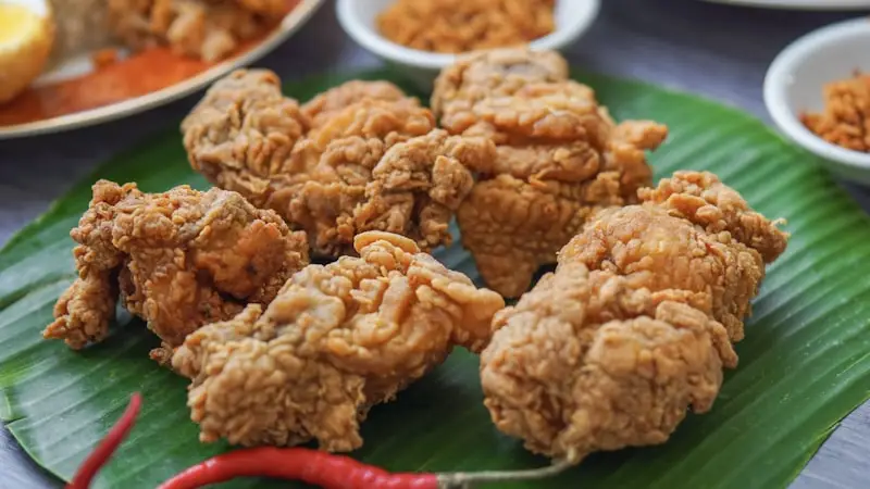 Plated Spicy Chicken Bites tossed in red chili sauce