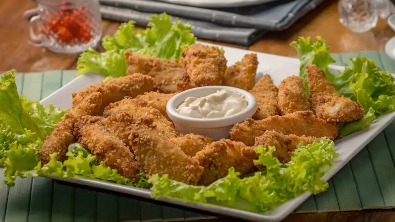 Crispy golden fried hand-breaded chicken tenders served with dipping sauce