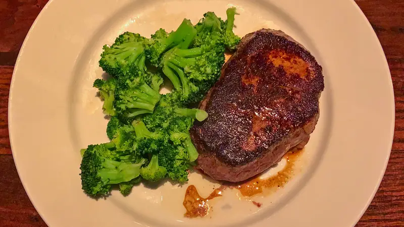Flo's Filet at LongHorn Steakhouse – tender filet mignon with fire-grilled char served alongside fresh steamed broccoli