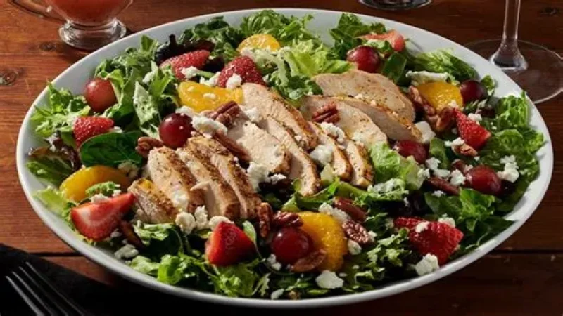 Grilled chicken and fresh strawberry salad with vinaigrette on a plate